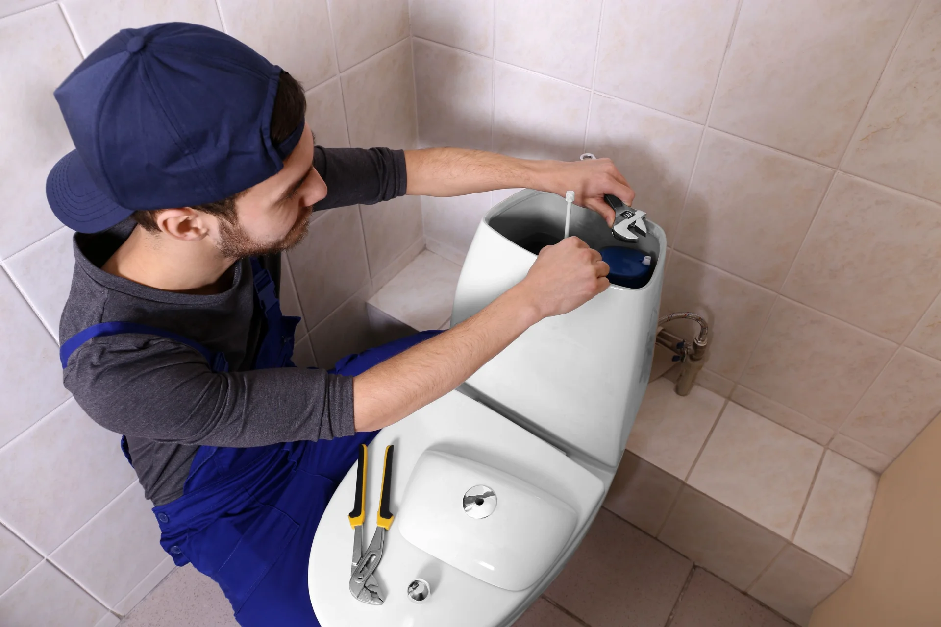 Professional plumber with service equipment